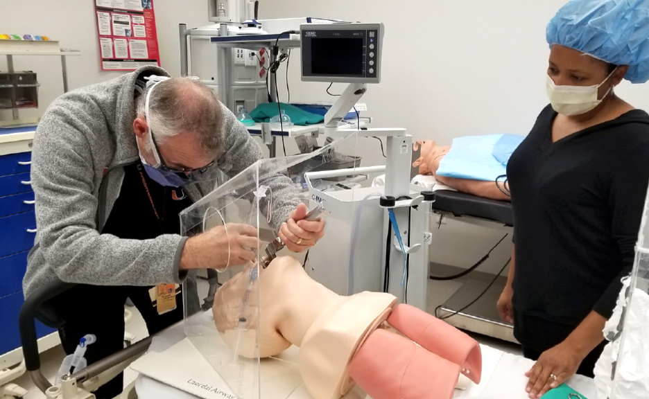 Richard McNeer and Nichole Crenshaw test an intubation box.