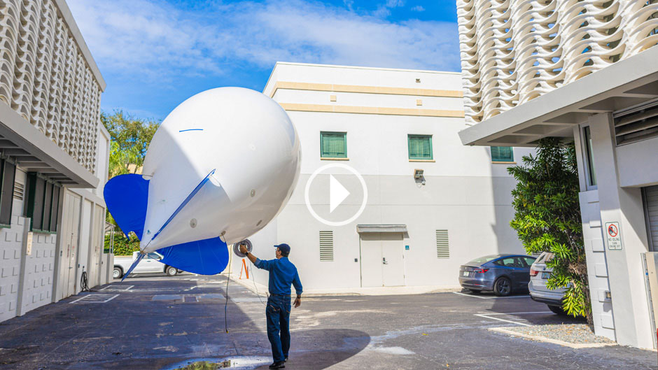 A smart balloon collects aerosol data at 200 feet of elevation over the McArthur Engineering Building.