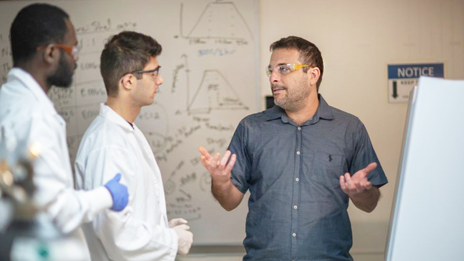 A highly competitive federal grant is helping Ali Ghahremaninezhad, right, and researchers improve infrastructure longevity.